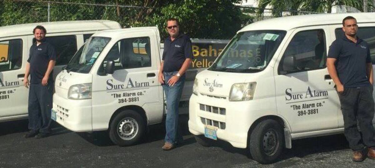 Sure Alarm Systems Technicians by their vans